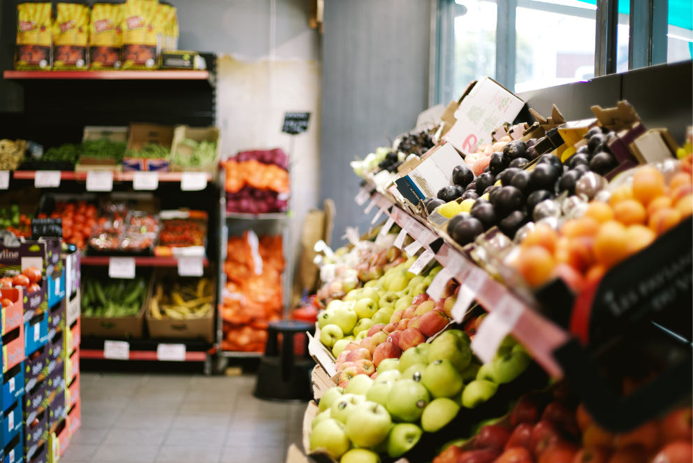 A family sits down to open a present. Hopelink Food Resources 10.30.25