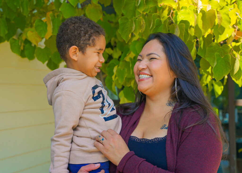 Family embracing outside of their home